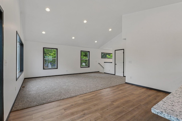 1002 Conway St, Saint Paul, MN 55106 - unfurnished room with high vaulted ceiling, wood finished floors, and recessed lighting