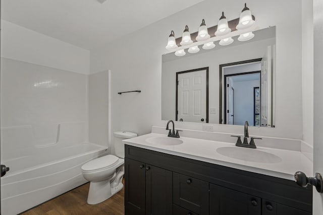 1002 Conway St, Saint Paul, MN 55106 - full bathroom with double vanity, wood finished floors, and shower / washtub combination