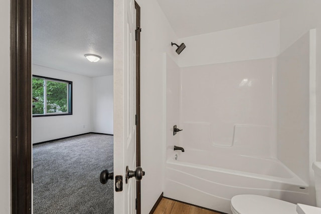 1002 Conway St, Saint Paul, MN 55106 - full bathroom featuring shower / bathtub combination and a textured ceiling