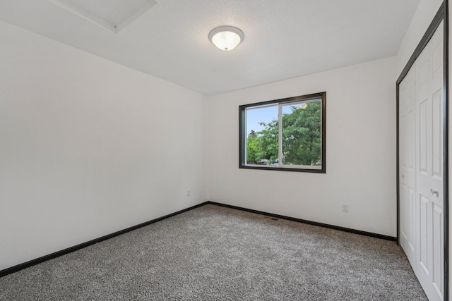 1002 Conway St, Saint Paul, MN 55106 - unfurnished bedroom with carpet floors, a closet, and attic access
