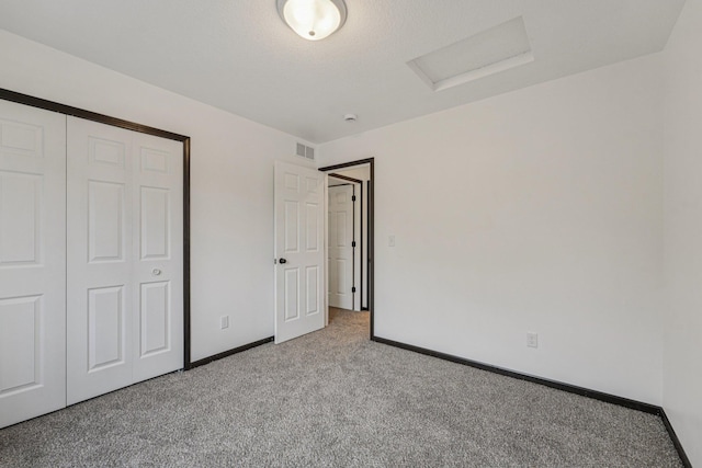 1002 Conway St, Saint Paul, MN 55106 - unfurnished bedroom with attic access, carpet flooring, and a closet