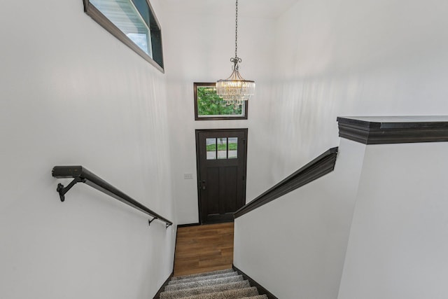 1002 Conway St, Saint Paul, MN 55106 - entrance foyer with a chandelier, wood finished floors, a high ceiling, and stairway