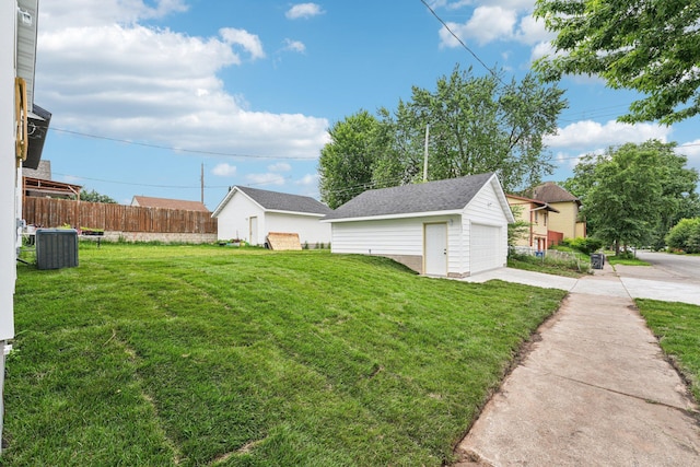 1002 Conway St, Saint Paul, MN 55106 - view of yard with an outbuilding, a garage, and driveway