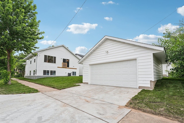 1002 Conway St, Saint Paul, MN 55106 - view of front facade featuring a front lawn, a garage, and an outdoor structure