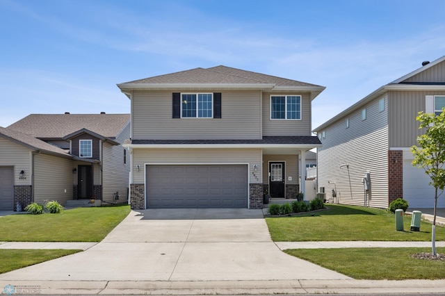 4822 34th Ave S, Fargo, ND 58104 - view of front of property with a front lawn, an attached garage, driveway, and roof with shingles
