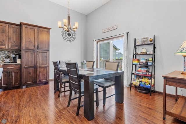 4822 34th Ave S, Fargo, ND 58104 - dining room featuring a chandelier, dark wood-style floors, and a towering ceiling