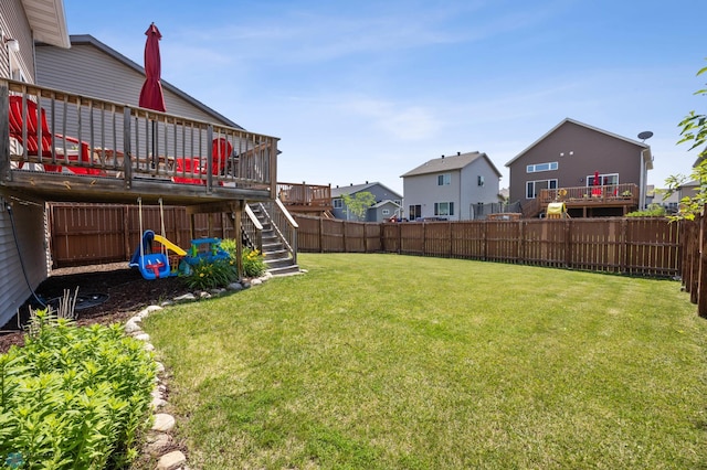 4822 34th Ave S, Fargo, ND 58104 - fenced backyard with a wooden deck, stairs, and a residential view