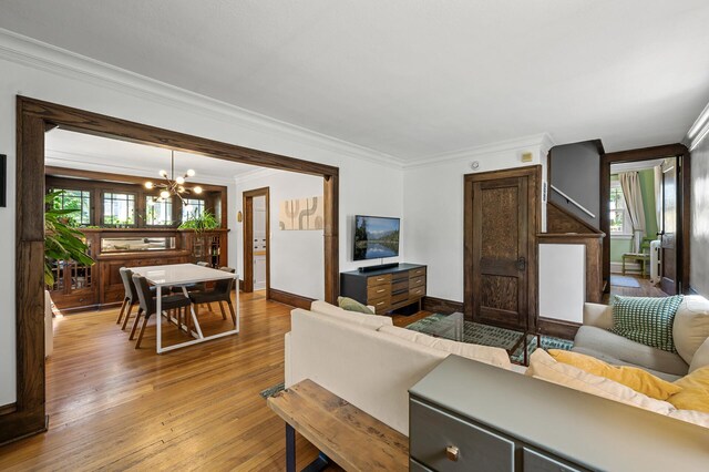 3841 Columbus Ave, Minneapolis, MN 55407 - living room featuring a chandelier, crown molding, plenty of natural light, and wood-type flooring