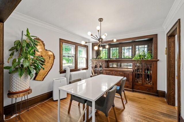 3841 Columbus Ave, Minneapolis, MN 55407 - dining room featuring a chandelier, crown molding, and light wood-style floors