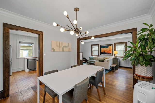 3841 Columbus Ave, Minneapolis, MN 55407 - dining space with hardwood / wood-style floors, radiator, a chandelier, and crown molding