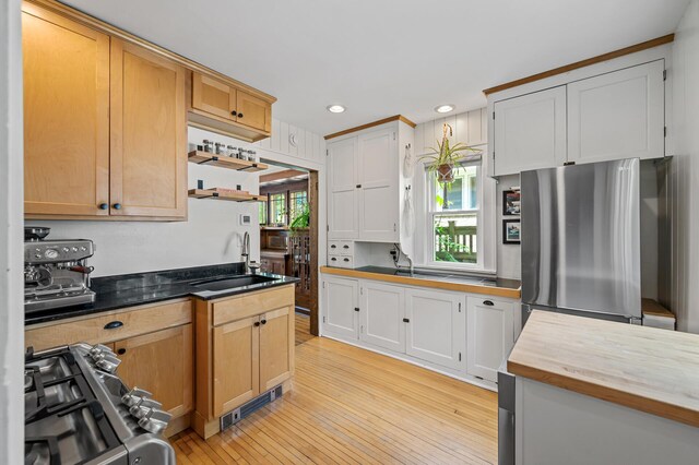 3841 Columbus Ave, Minneapolis, MN 55407 - kitchen featuring stainless steel appliances, light wood-type flooring, recessed lighting, butcher block counters, and open shelves