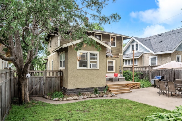 3841 Columbus Ave, Minneapolis, MN 55407 - back of house featuring a fenced backyard, stucco siding, a patio, and a gate
