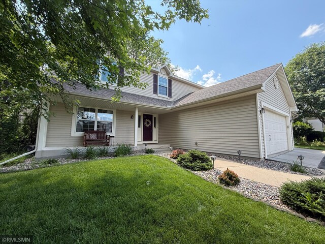 2052 Wilhelm Ct, Shakopee, MN 55379 - traditional-style house featuring an attached garage, a porch, a front yard, and driveway