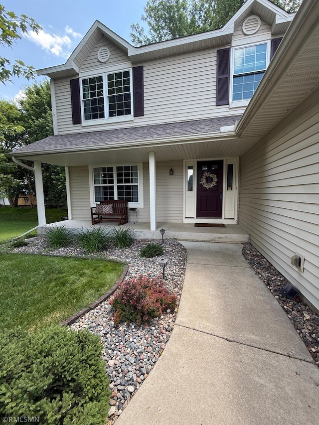 2052 Wilhelm Ct, Shakopee, MN 55379 - view of front of property featuring a porch, roof with shingles, and a front lawn