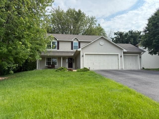 2052 Wilhelm Ct, Shakopee, MN 55379 - view of front facade with an attached garage, driveway, and a front lawn