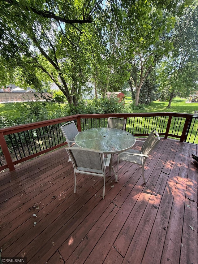 2052 Wilhelm Ct, Shakopee, MN 55379 - wooden deck featuring outdoor dining area and a yard