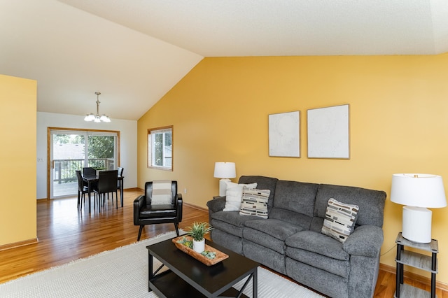 4626 Savannah Dr NW, Rochester, MN 55901 - living room featuring wood finished floors, a chandelier, and vaulted ceiling