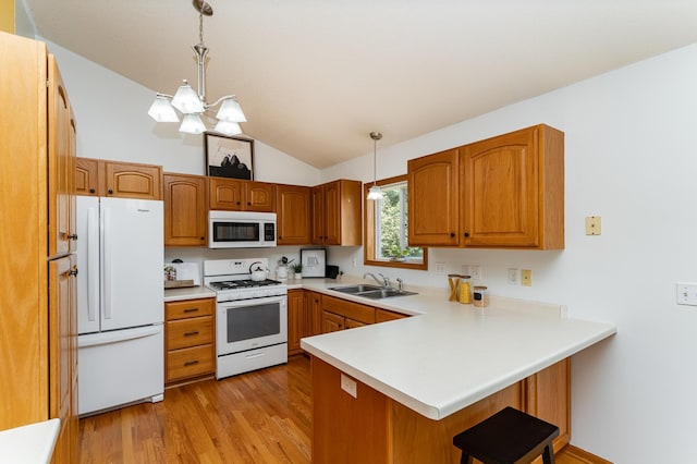 4626 Savannah Dr NW, Rochester, MN 55901 - kitchen with white appliances, a peninsula, vaulted ceiling, a kitchen breakfast bar, and light wood-style floors