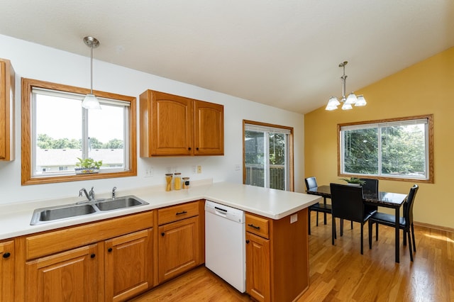 4626 Savannah Dr NW, Rochester, MN 55901 - kitchen featuring white dishwasher, a peninsula, vaulted ceiling, brown cabinetry, and a chandelier