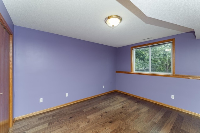 4626 Savannah Dr NW, Rochester, MN 55901 - unfurnished bedroom with wood finished floors and a textured ceiling