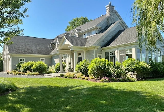 1105 Ferndale Rd W, Orono, MN 55391 - rear view of house with a chimney, roof with shingles, and a yard