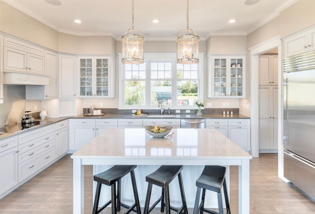1105 Ferndale Rd W, Orono, MN 55391 - kitchen featuring appliances with stainless steel finishes, a breakfast bar, light wood-type flooring, crown molding, and recessed lighting