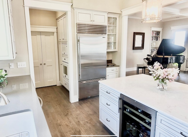 1105 Ferndale Rd W, Orono, MN 55391 - kitchen featuring built in appliances, beverage cooler, light wood-style floors, glass insert cabinets, and light countertops