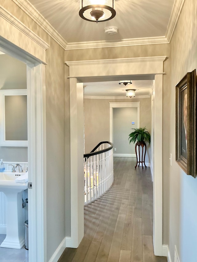 1105 Ferndale Rd W, Orono, MN 55391 - hall featuring ornamental molding, wood finished floors, and an upstairs landing