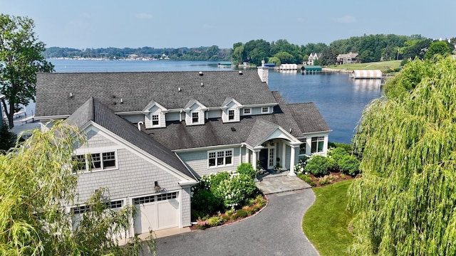 1105 Ferndale Rd W, Orono, MN 55391 - view of front facade featuring a water view, a shingled roof, and asphalt driveway