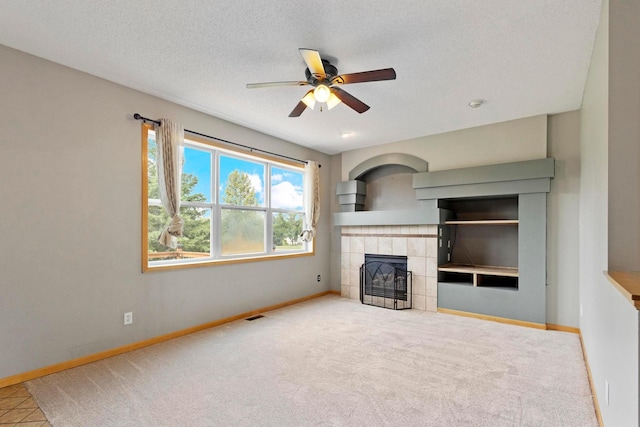 14192 Bayberry Trl, Rosemount, MN 55068 - unfurnished living room featuring a fireplace, a ceiling fan, carpet floors, and a textured ceiling