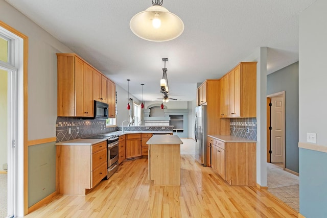 14192 Bayberry Trl, Rosemount, MN 55068 - kitchen with stainless steel appliances, ceiling fan, light countertops, light wood-style flooring, and decorative backsplash