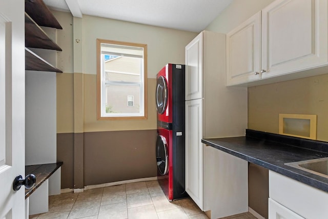 14192 Bayberry Trl, Rosemount, MN 55068 - kitchen featuring stacked washing machine and dryer, dark countertops, open shelves, white cabinets, and light tile patterned floors