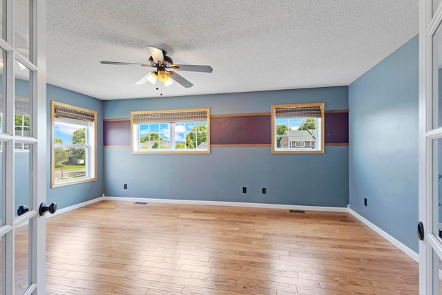 14192 Bayberry Trl, Rosemount, MN 55068 - unfurnished room with a textured ceiling, ceiling fan, light wood-type flooring, and french doors