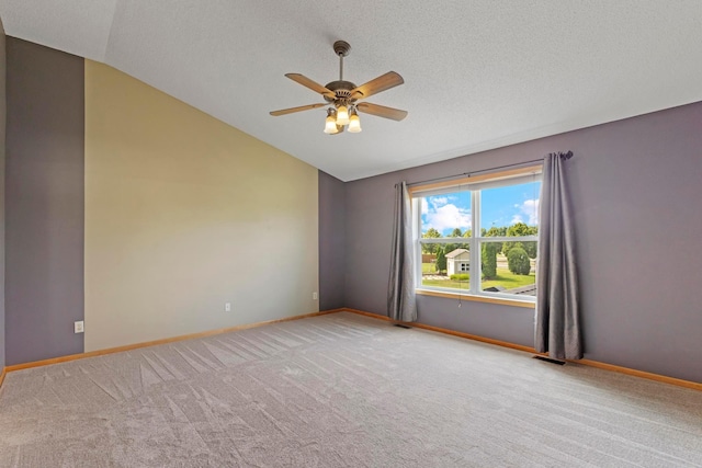 14192 Bayberry Trl, Rosemount, MN 55068 - spare room with vaulted ceiling, a ceiling fan, light carpet, and a textured ceiling