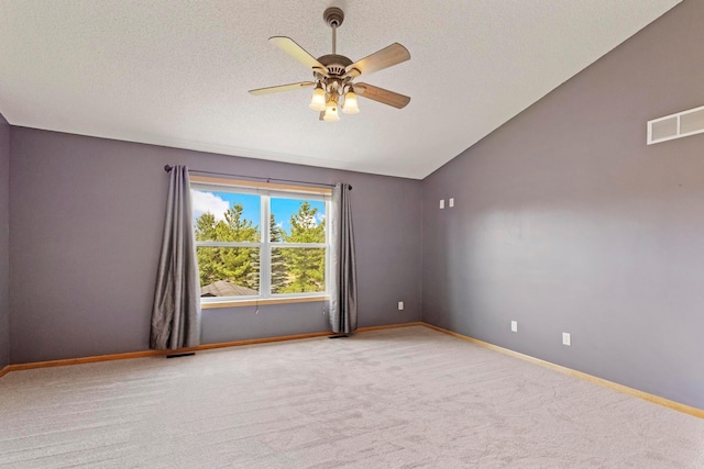 14192 Bayberry Trl, Rosemount, MN 55068 - empty room with vaulted ceiling, ceiling fan, carpet flooring, and a textured ceiling