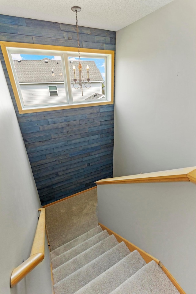 14192 Bayberry Trl, Rosemount, MN 55068 - stairway featuring a chandelier and a textured ceiling