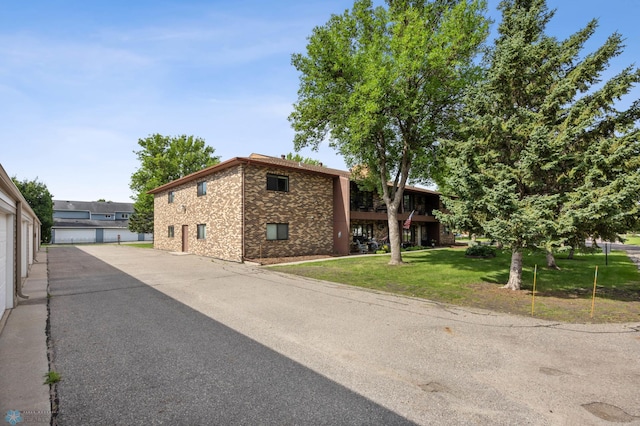 2636 18th St S Unit 8, Fargo, ND 58103 - view of property exterior with a yard and stone siding