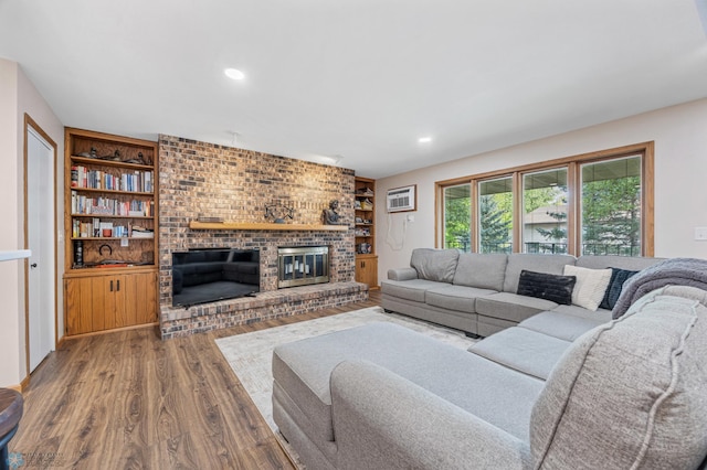 2636 18th St S Unit 8, Fargo, ND 58103 - living area with a fireplace, wood finished floors, recessed lighting, an AC wall unit, and built in shelves