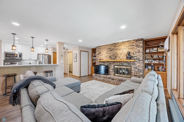 2636 18th St S Unit 8, Fargo, ND 58103 - living room with recessed lighting, light wood-type flooring, and a fireplace