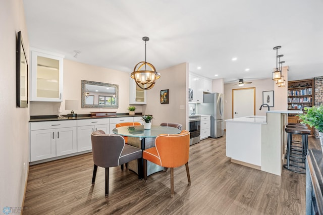 2636 18th St S Unit 8, Fargo, ND 58103 - dining area with wood finished floors, a chandelier, recessed lighting, and a ceiling fan