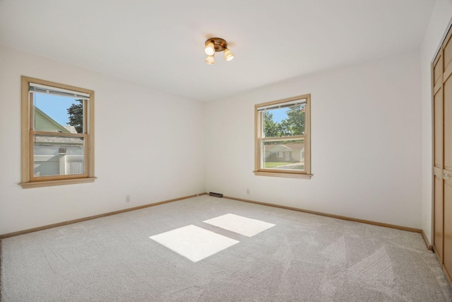8300 Sheridan Ave S, Bloomington, MN 55431 - unfurnished bedroom featuring multiple windows, light carpet, and a closet