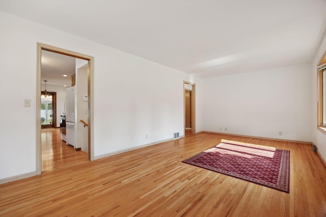 8300 Sheridan Ave S, Bloomington, MN 55431 - empty room featuring light wood-style floors and a chandelier