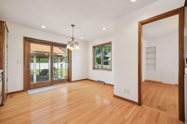 8300 Sheridan Ave S, Bloomington, MN 55431 - spare room with light wood-style flooring, healthy amount of natural light, a chandelier, recessed lighting, and built in shelves