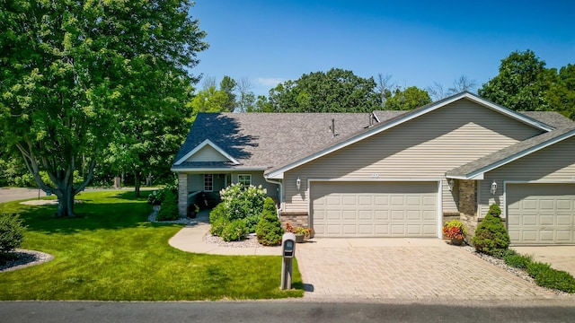 10 Cree Point Dr, Mankato, MN 56001 - view of front of house with a front lawn, decorative driveway, brick siding, an attached garage, and a shingled roof