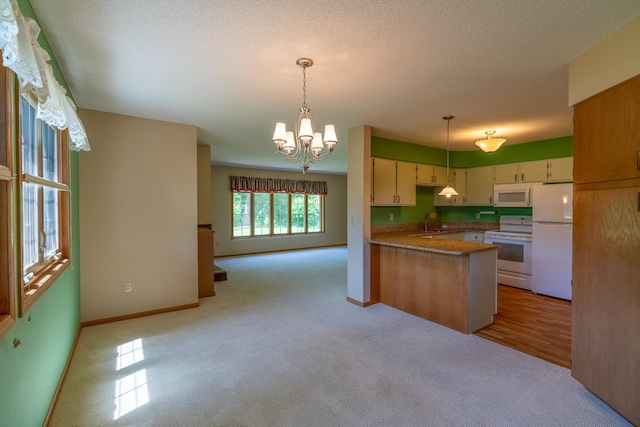 10 Cree Point Dr, Mankato, MN 56001 - kitchen with white appliances, light carpet, a peninsula, a chandelier, and open floor plan