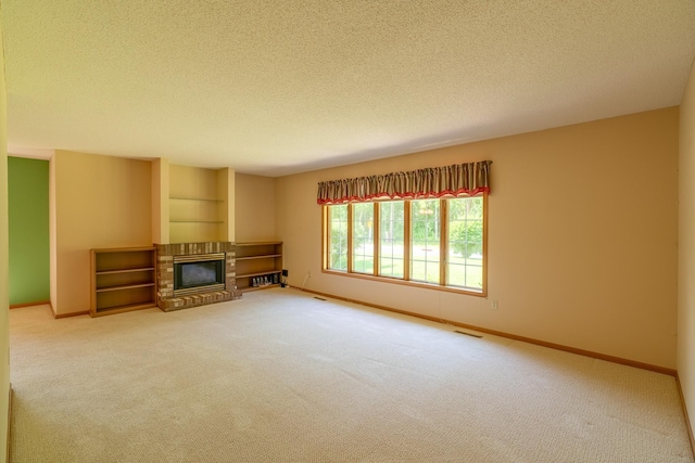 10 Cree Point Dr, Mankato, MN 56001 - unfurnished living room with a textured ceiling, a fireplace, and carpet flooring