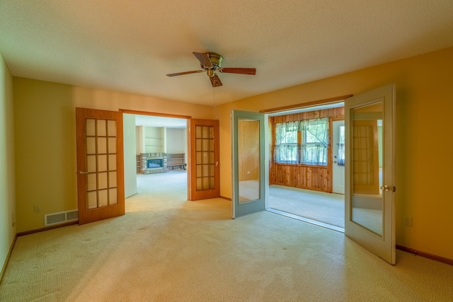 10 Cree Point Dr, Mankato, MN 56001 - carpeted empty room featuring french doors, a ceiling fan, and a textured ceiling