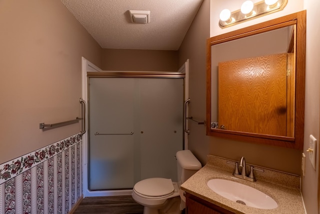 10 Cree Point Dr, Mankato, MN 56001 - full bath with a stall shower, a textured ceiling, vanity, wood finished floors, and wainscoting