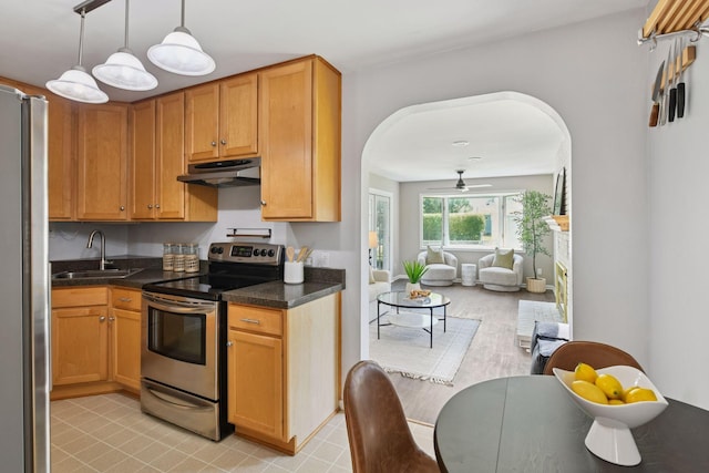 5917 Oliver Ave S, Minneapolis, MN 55419 - kitchen with appliances with stainless steel finishes, under cabinet range hood, arched walkways, open floor plan, and hanging light fixtures