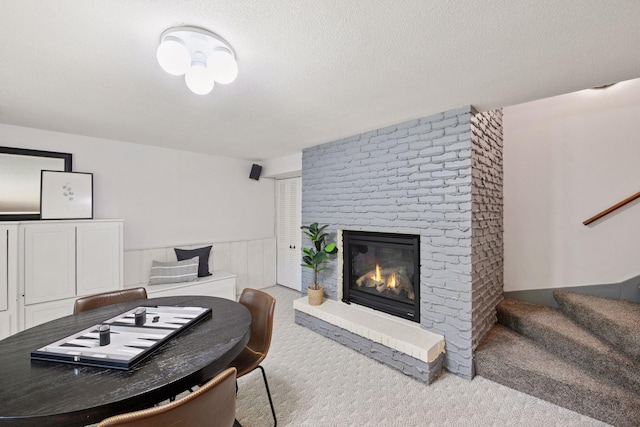 3918 Willmatt Hl, Minnetonka, MN 55305 - living area with carpet, a fireplace, stairs, and a textured ceiling